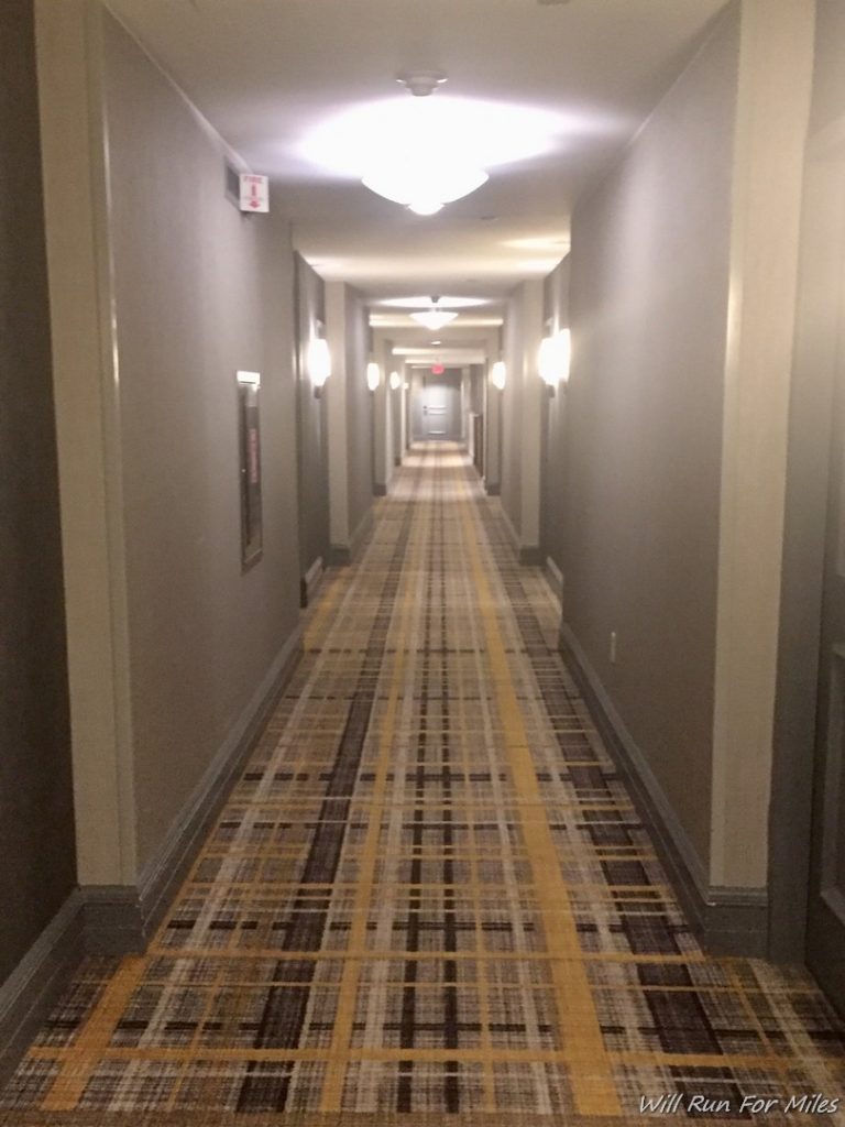 a hallway with a checkered carpet