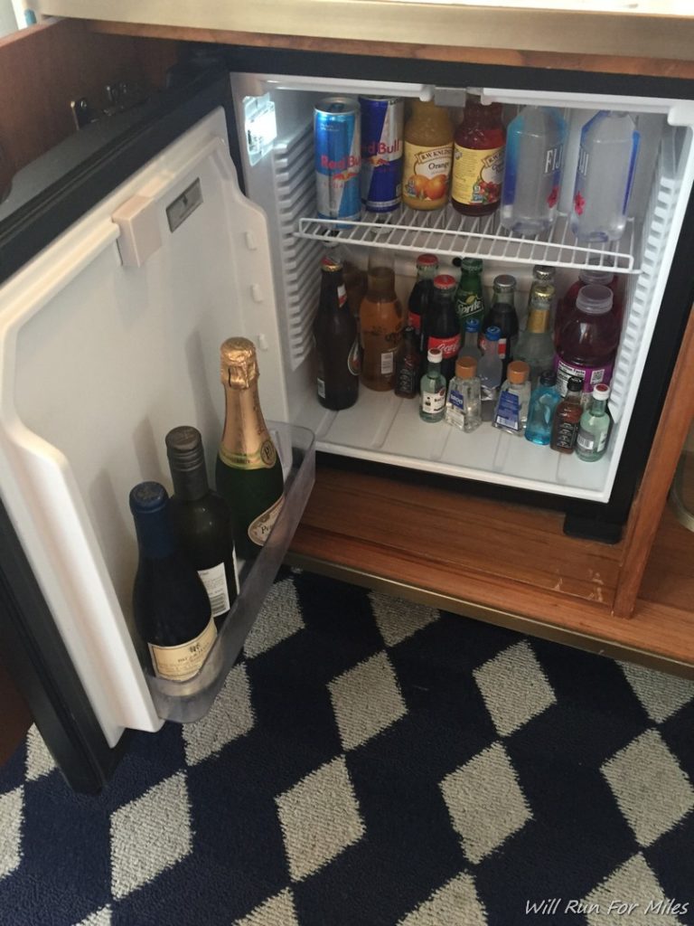 a mini fridge with bottles of alcohol