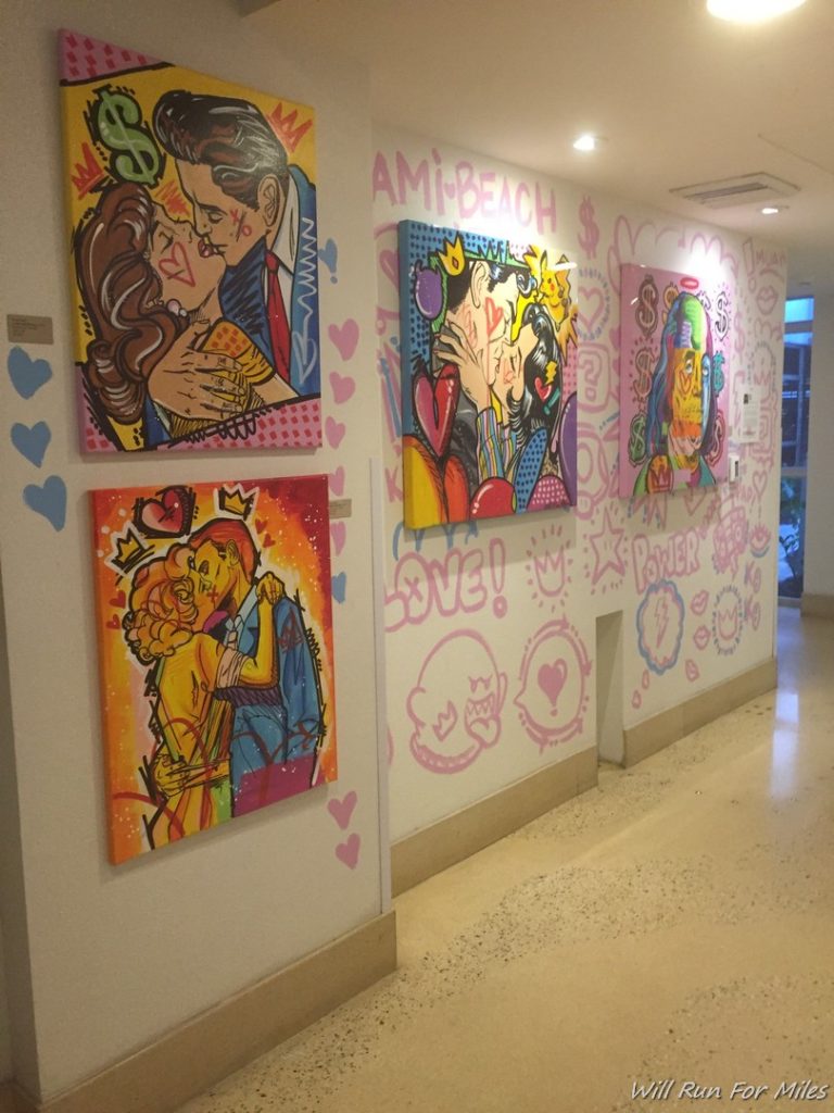 a hallway with paintings on the wall