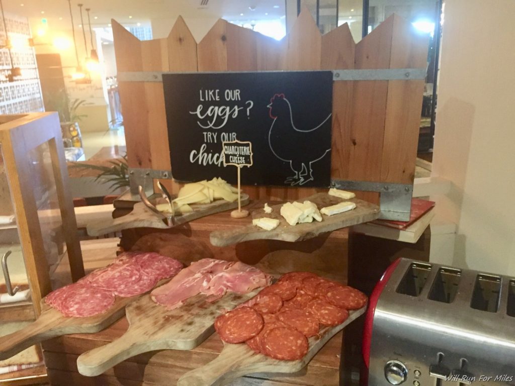 a table with different types of meats and cheese