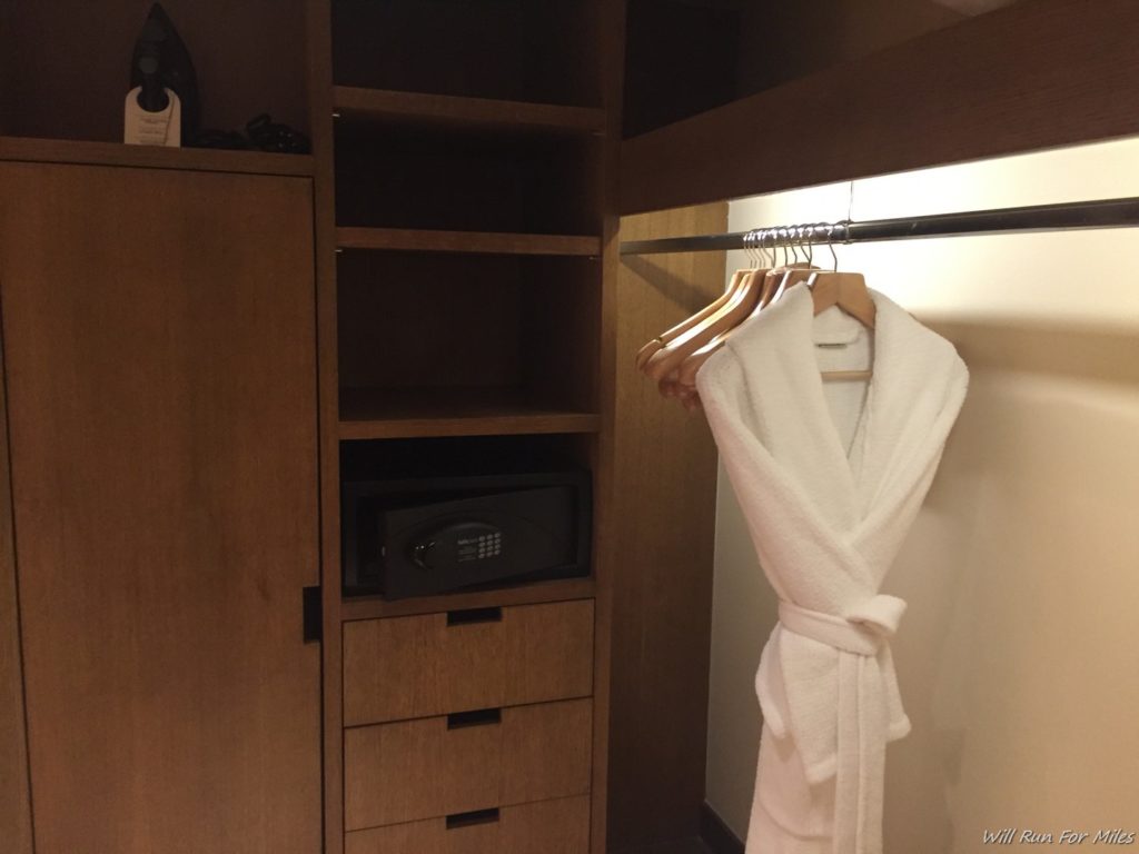 a white robe on swingers in a closet