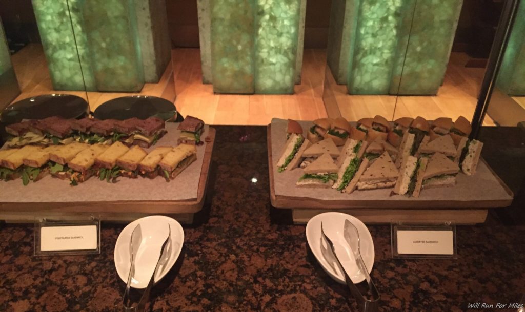 sandwiches on a table with plates of sandwiches