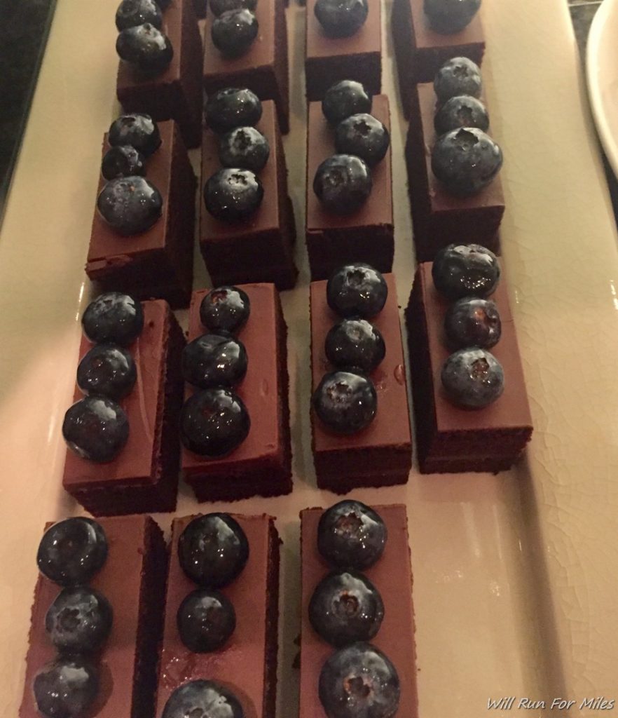 a plate of chocolate desserts with blueberries