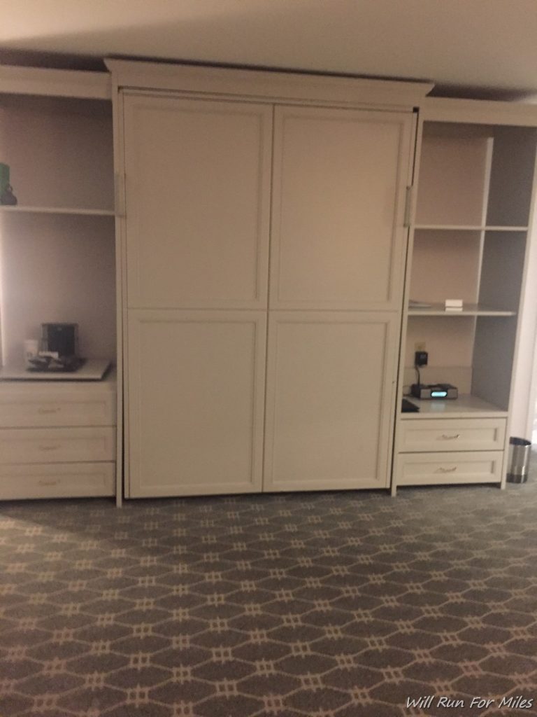 a large white cabinet with drawers and drawers