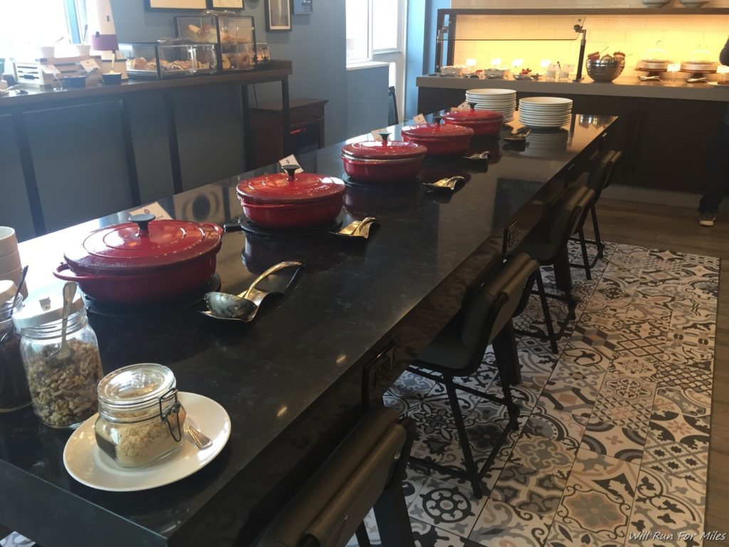 a long black table with red pots on it