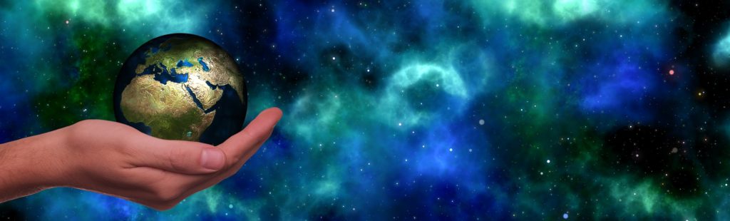 a finger pointing at a blue and green space