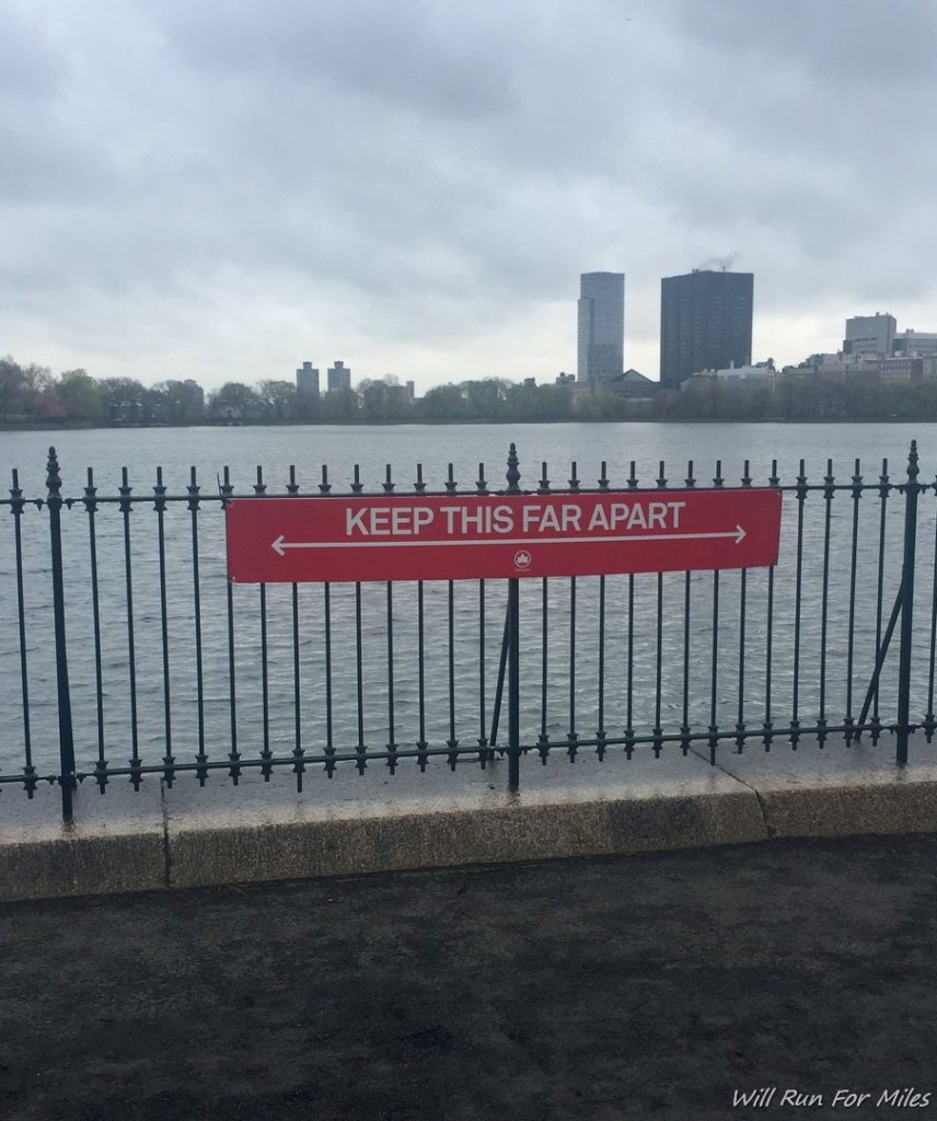a sign on a fence by water