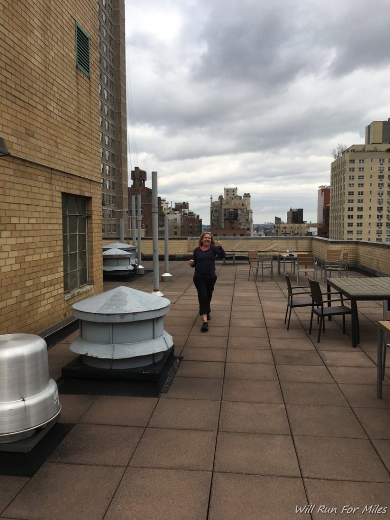 a woman running on a rooftop