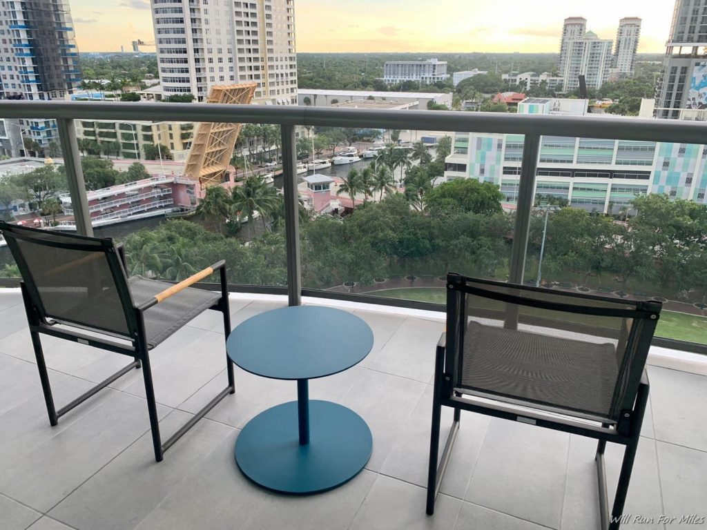 a balcony with chairs and a table