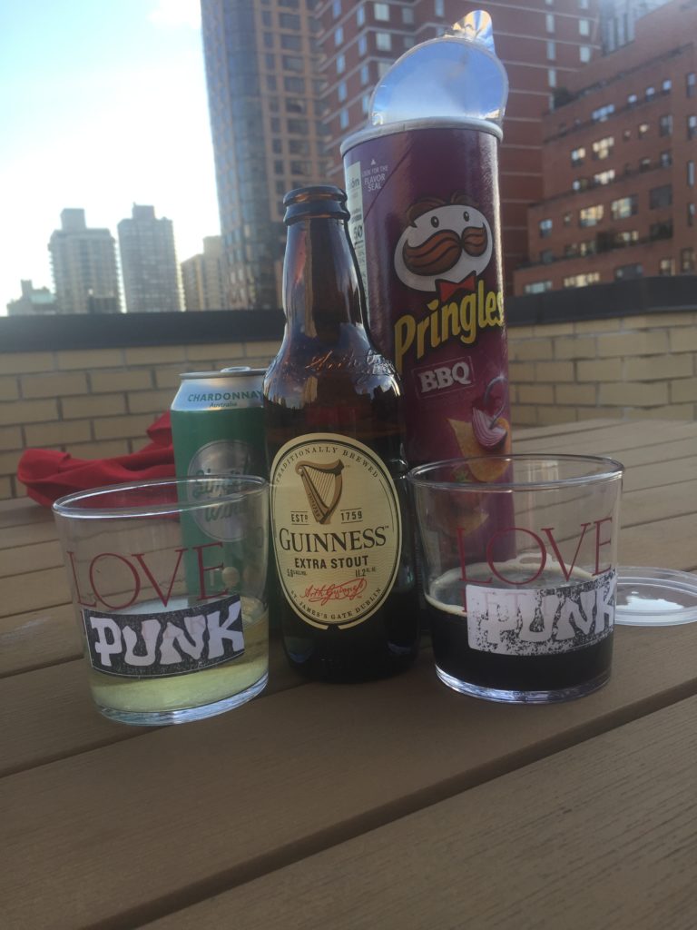 a bottle of beer and two glasses on a table