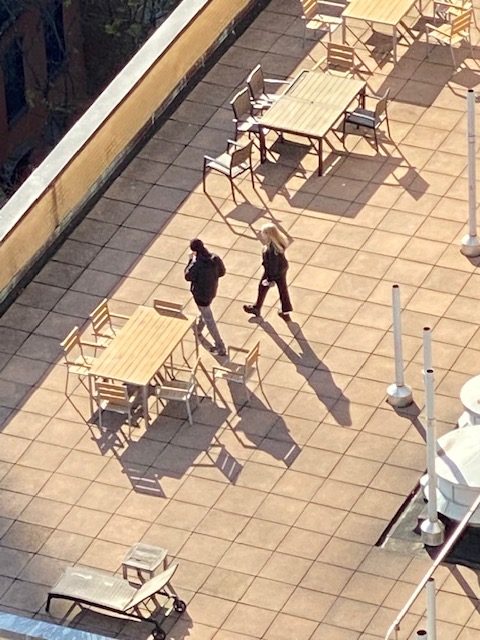 a couple of people walking on a patio