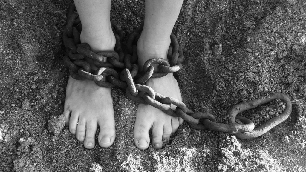 a person's feet tied with a chain