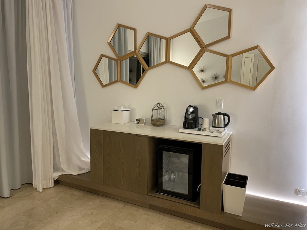 a coffee machine and a mirror on a wall