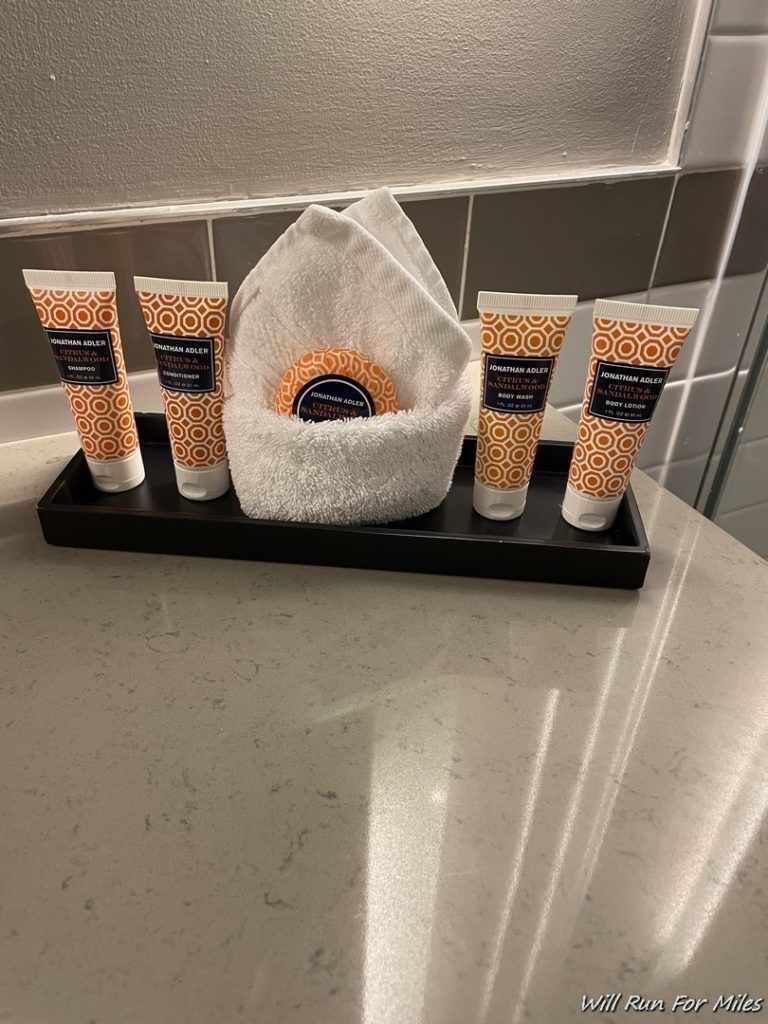 a group of tubes of cream and a towel on a counter