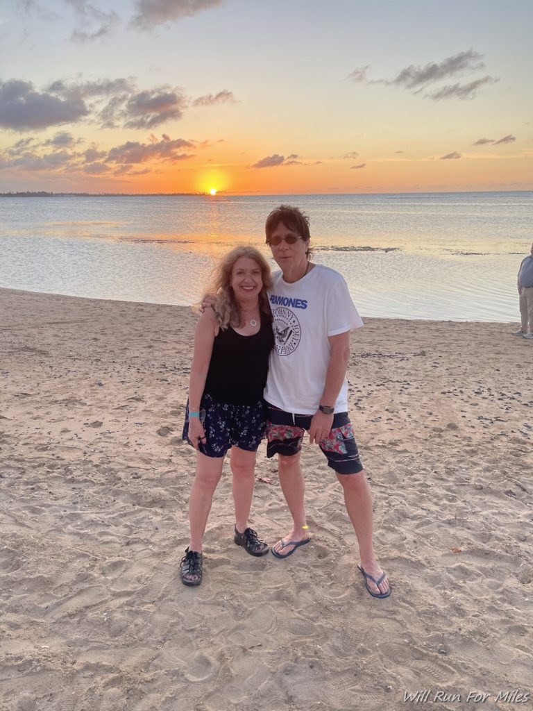 a couple of people standing on a beach
