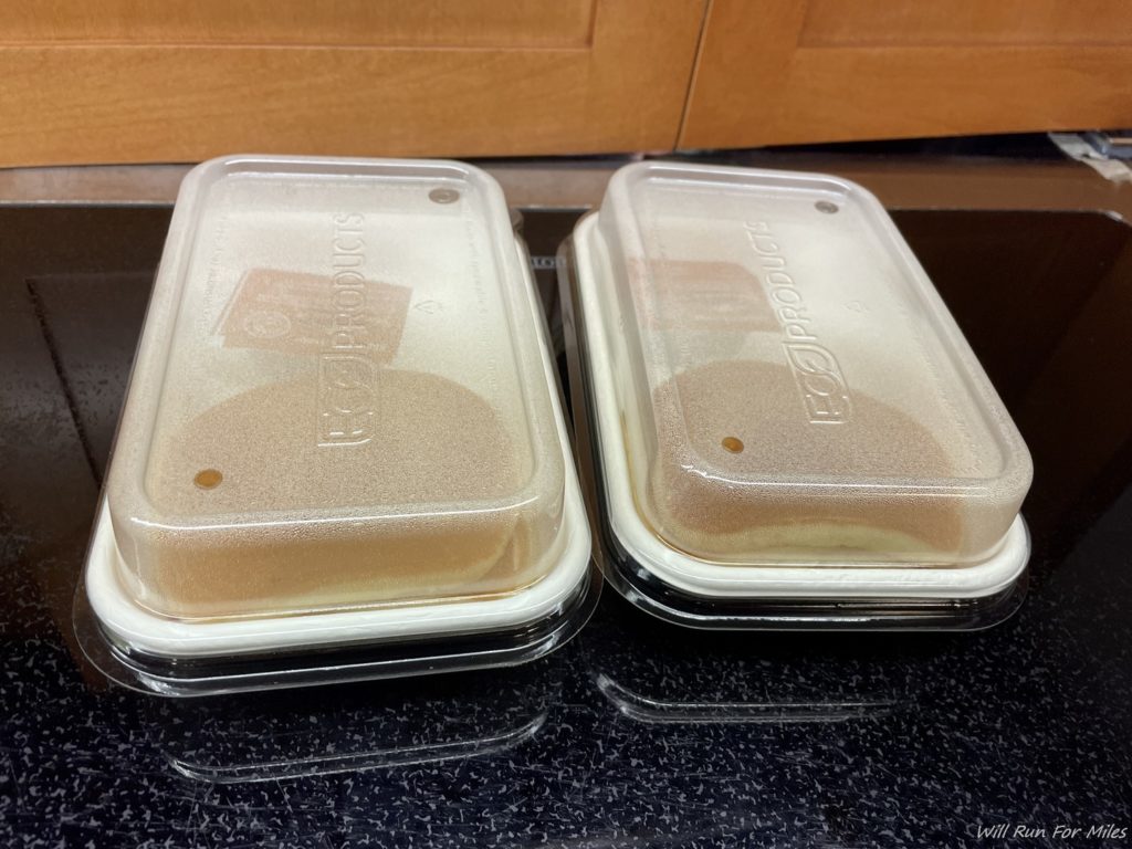 two plastic containers with food on them