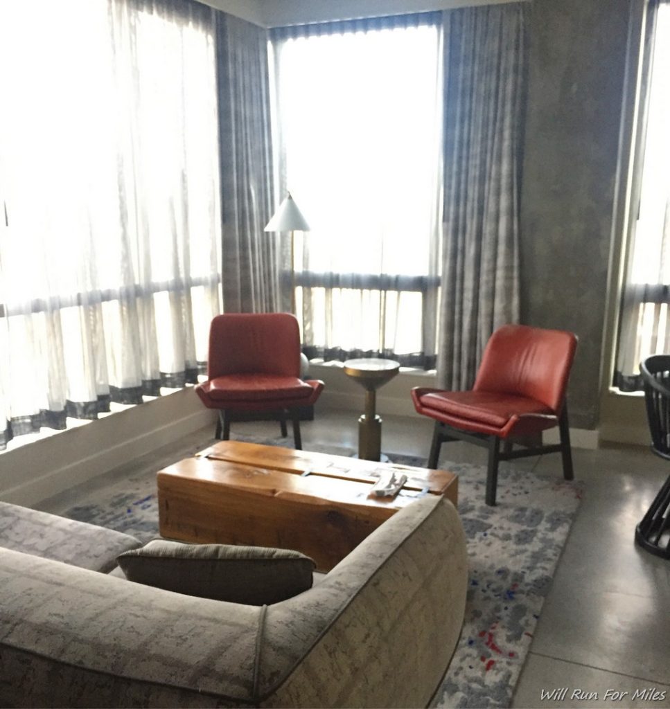 a room with a couch and chairs
