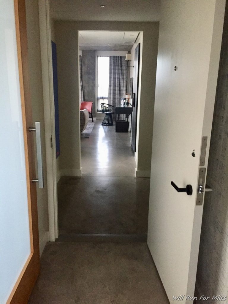 a hallway with a door and a table