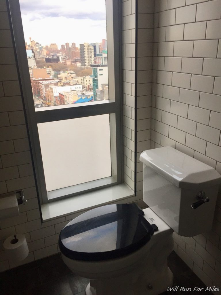 a toilet in a bathroom with a window