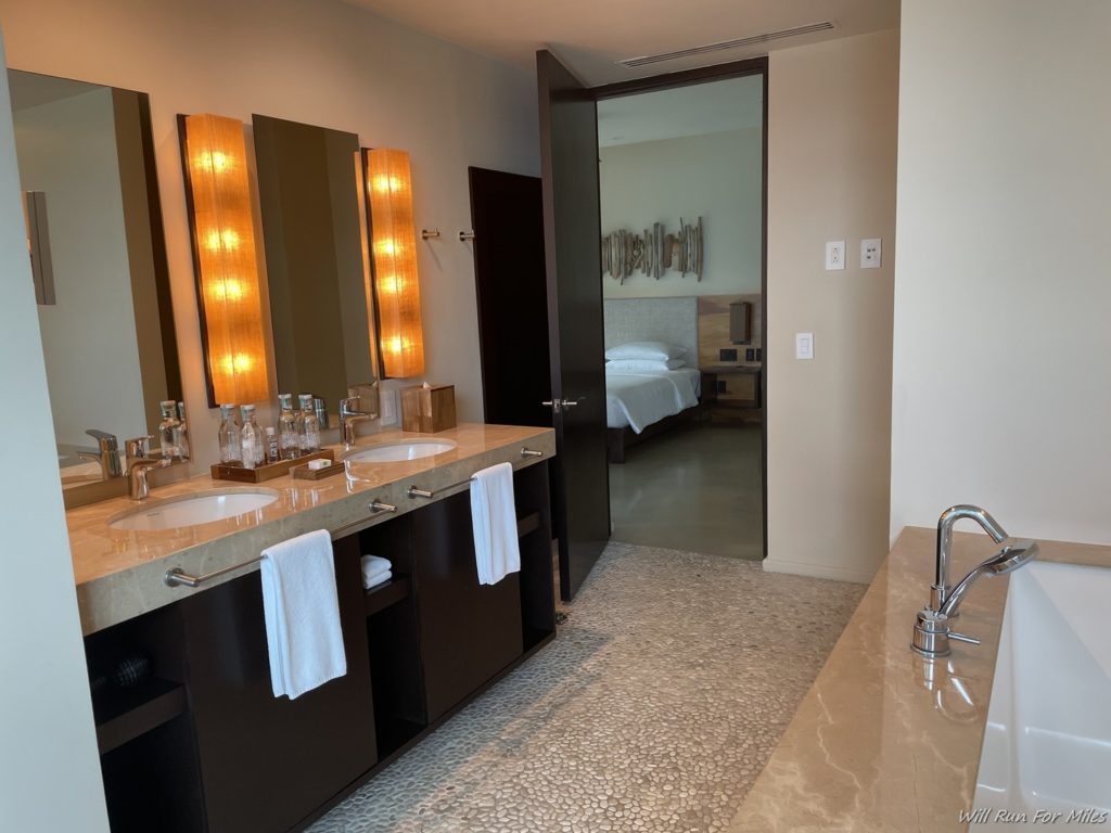 a bathroom with a double sink and mirrors