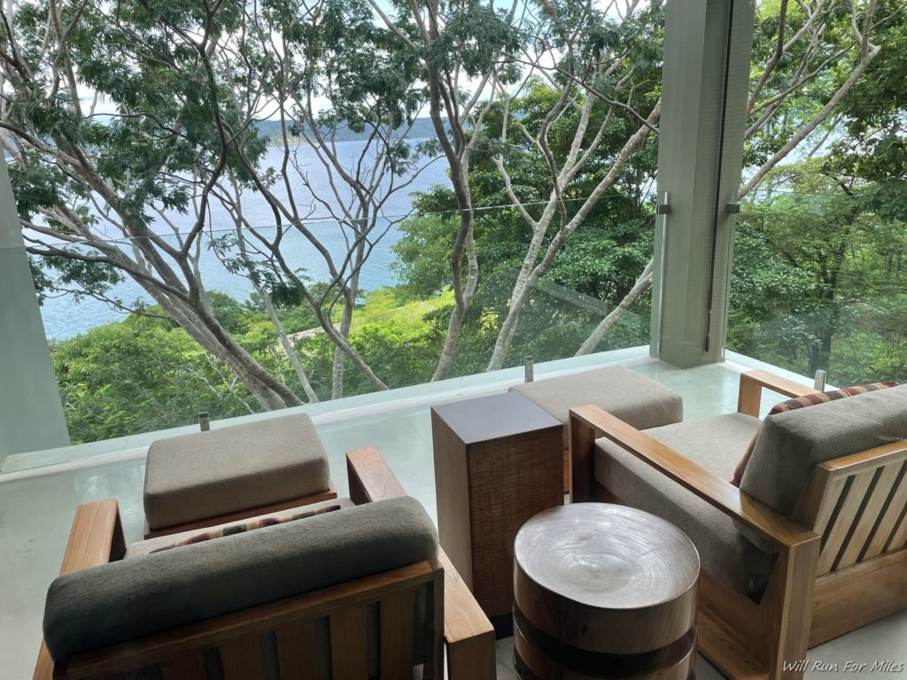 a room with a view of the water and trees