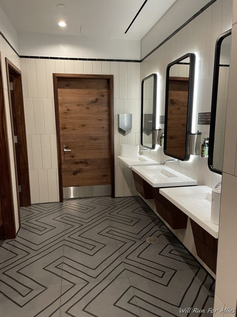 a bathroom with sinks and a door
