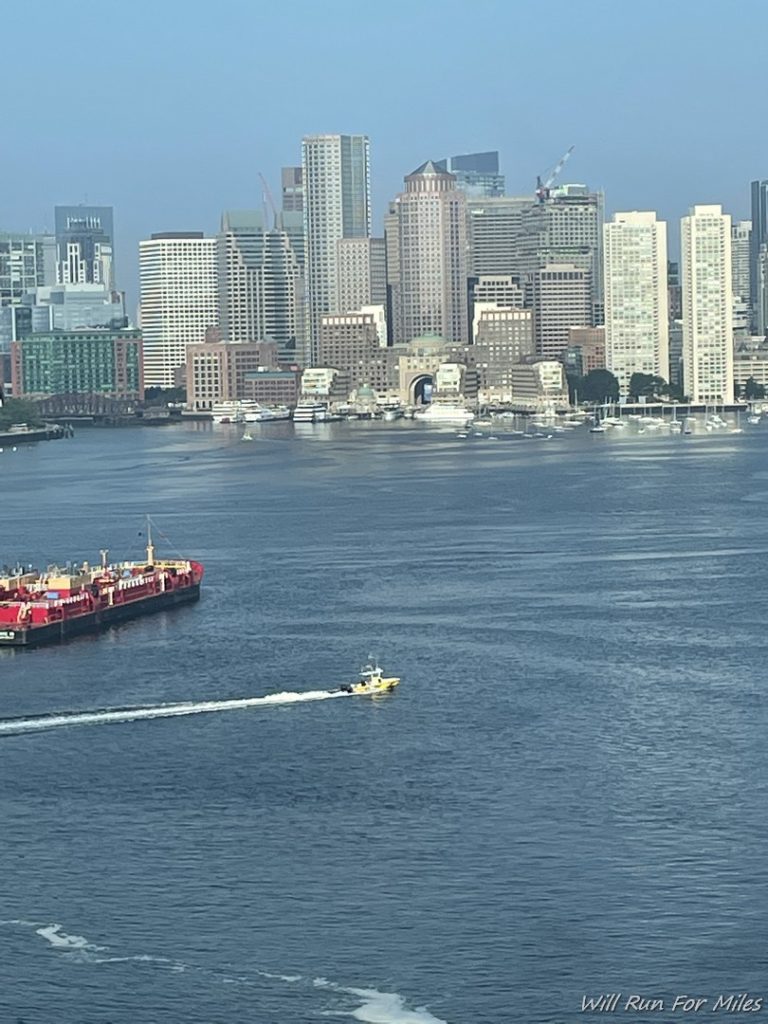 a boat in the water with a city in the background