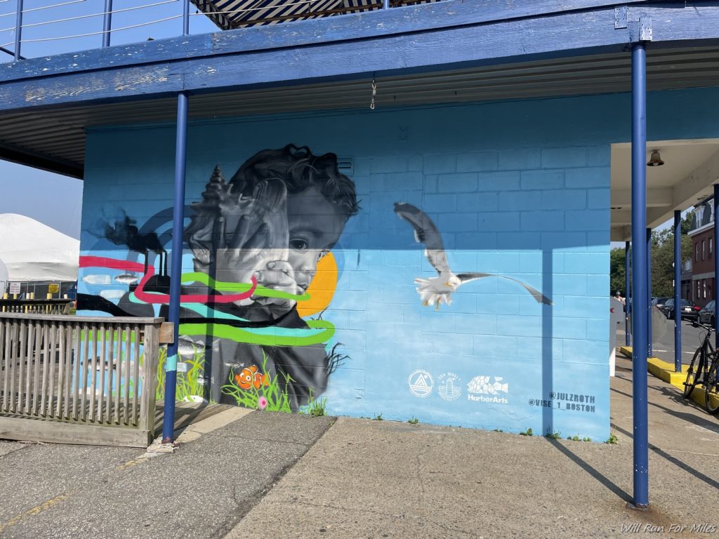 a blue wall with a mural of a baby