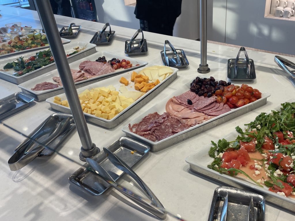 a buffet table with trays of food