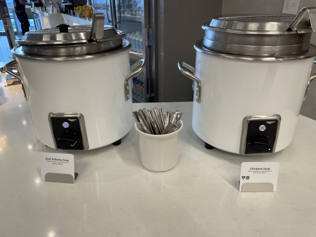 two large white pots with silver lids
