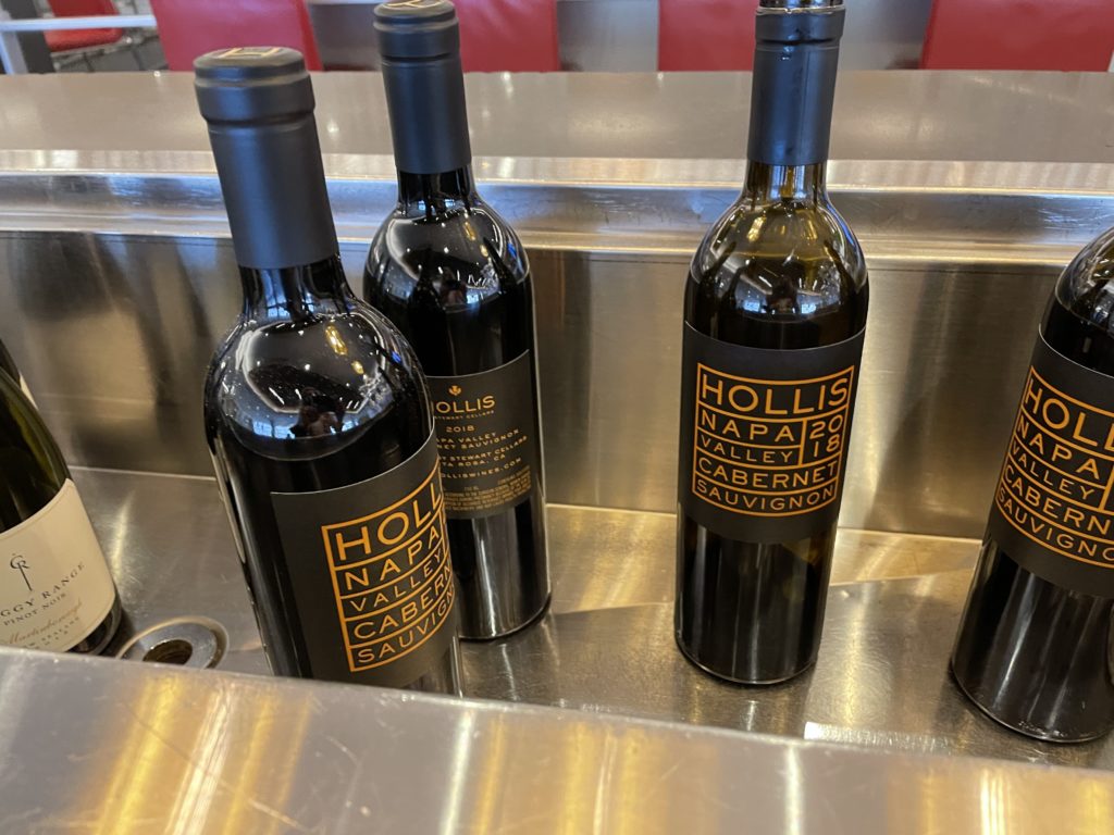 a group of wine bottles on a metal counter
