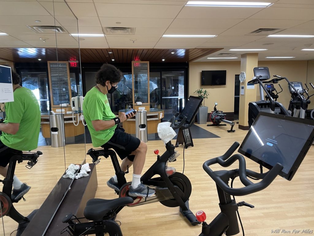 a man on a stationary bike in a gym