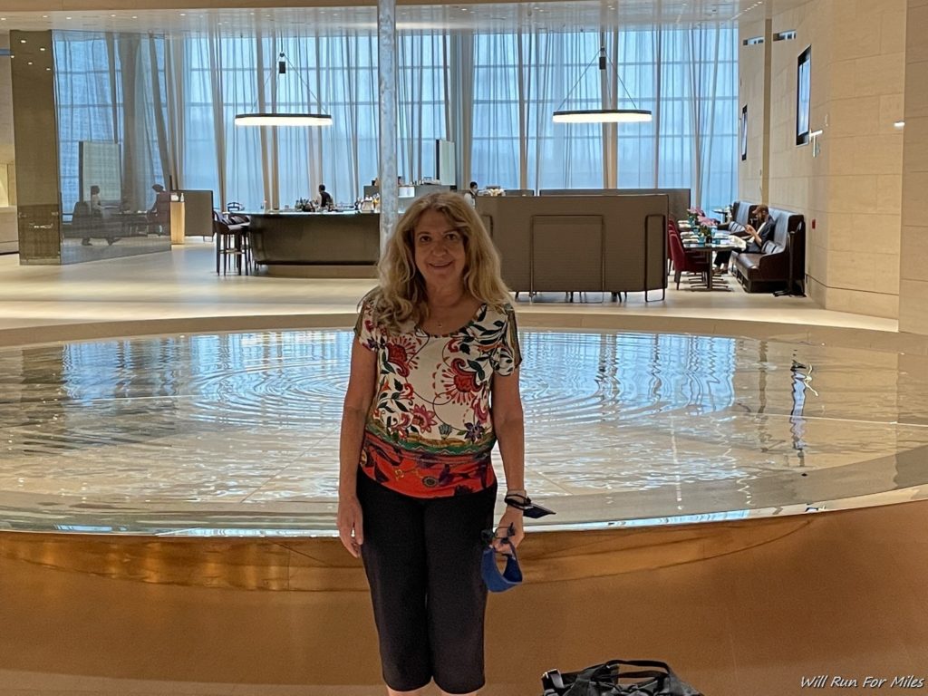 a woman standing in front of a pool
