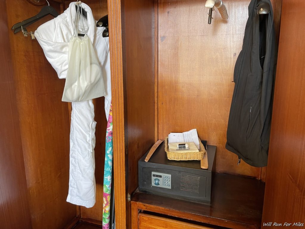 a closet with clothes and a safe