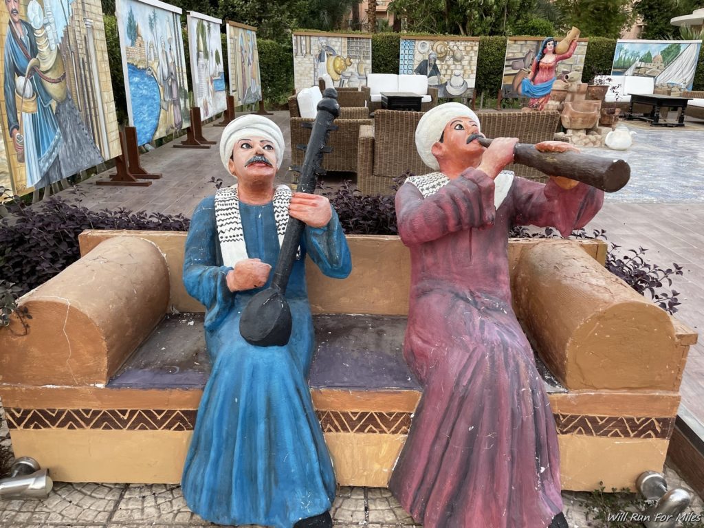 statues of men sitting on a bench