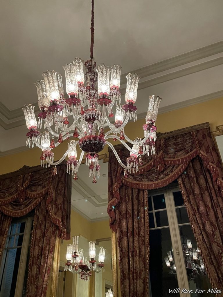 a chandelier with crystal glass shades from the ceiling