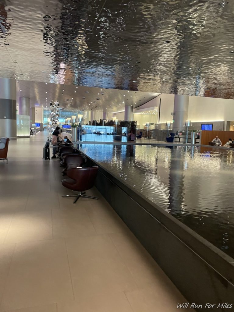 a large indoor pool with water running down the side