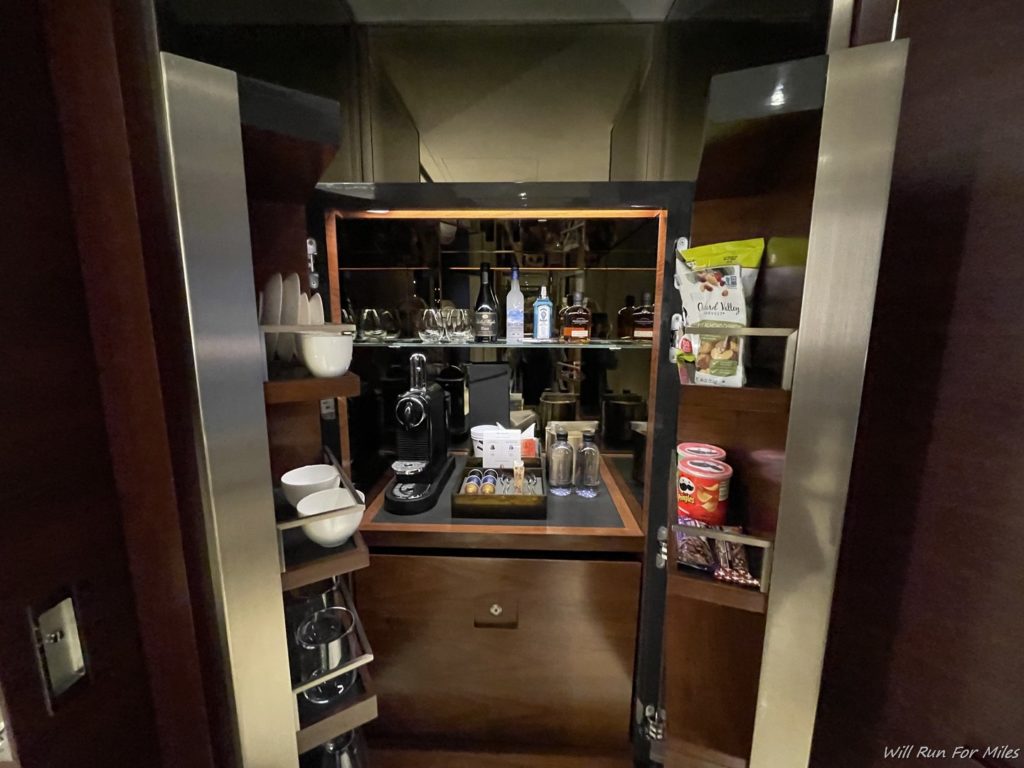 a kitchen cabinet with a shelf full of food and drinks