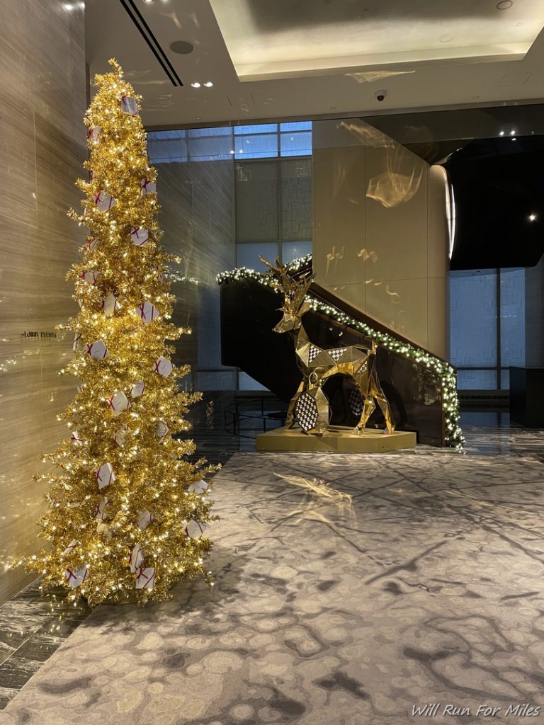 a gold christmas tree in a room