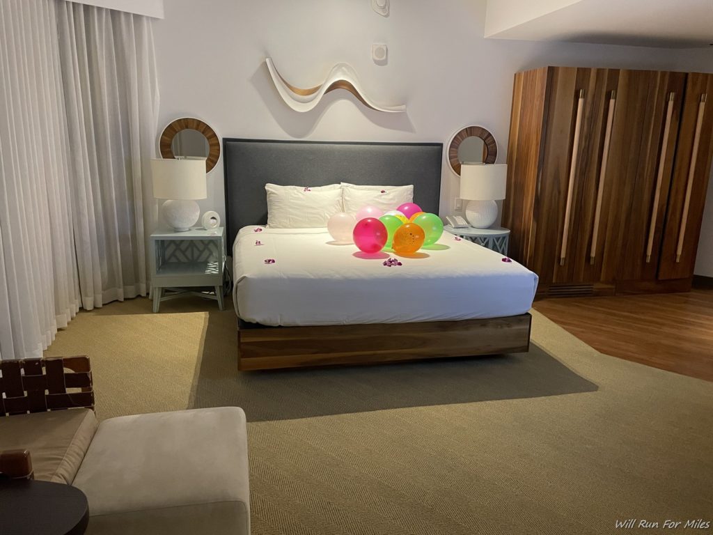 a bed with balloons on it