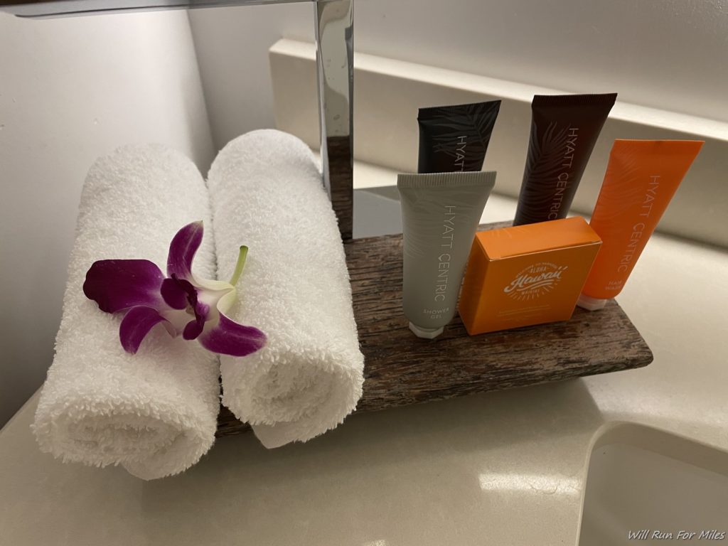 a towel and toiletries on a wood tray