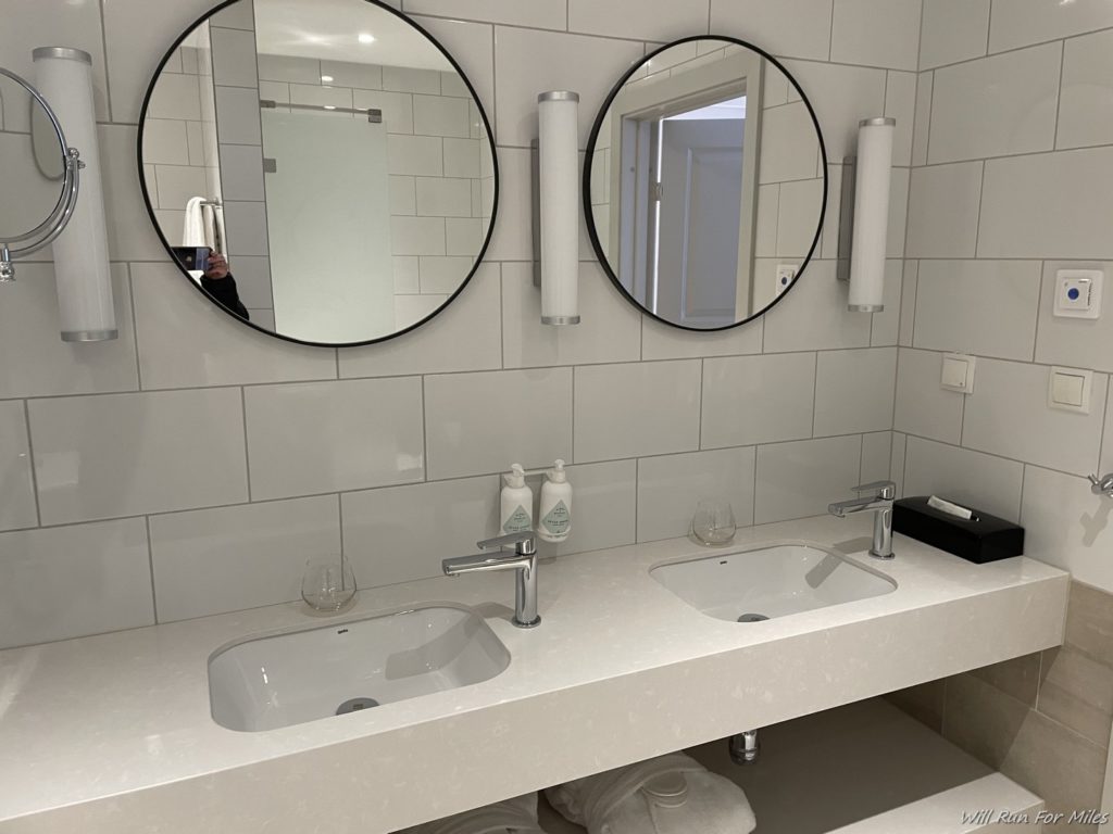 a bathroom with two mirrors