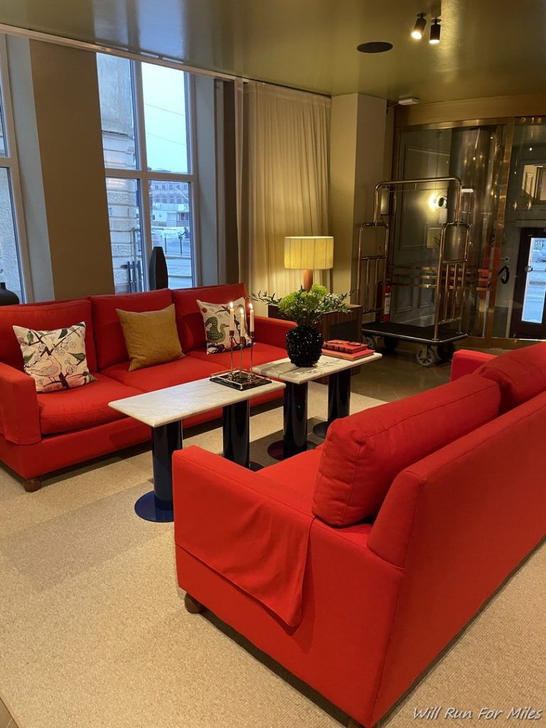 a room with red couches and a table