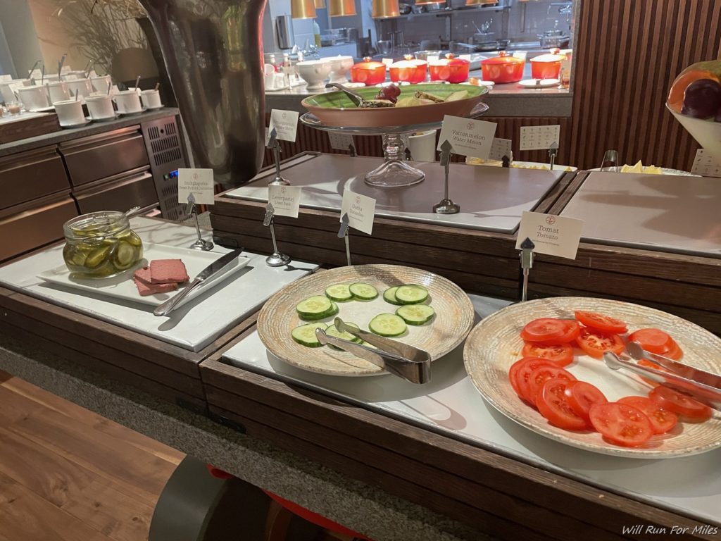 a buffet table with plates of food
