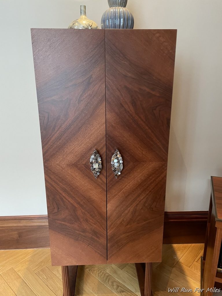 a wooden cabinet with handles
