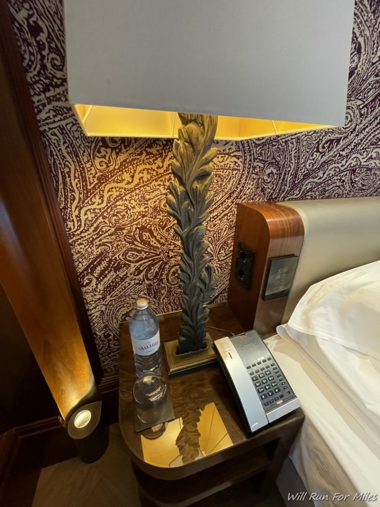 a phone and a lamp on a nightstand