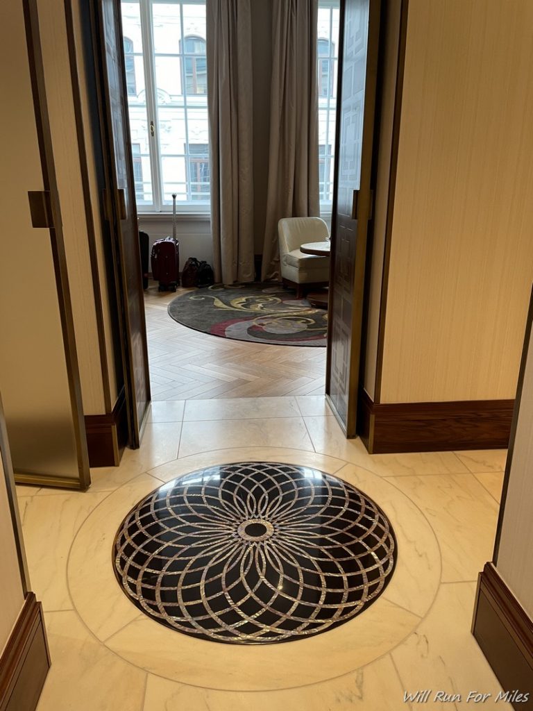 a door open to a room with a circular rug