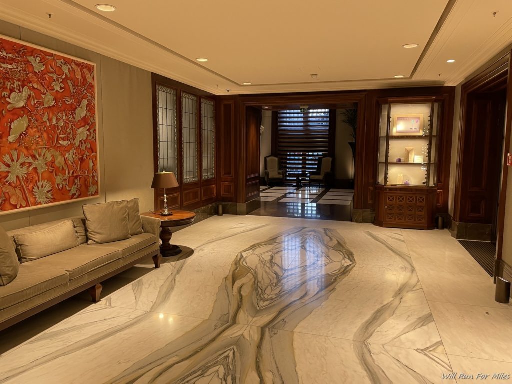 a room with a marble floor and a couch