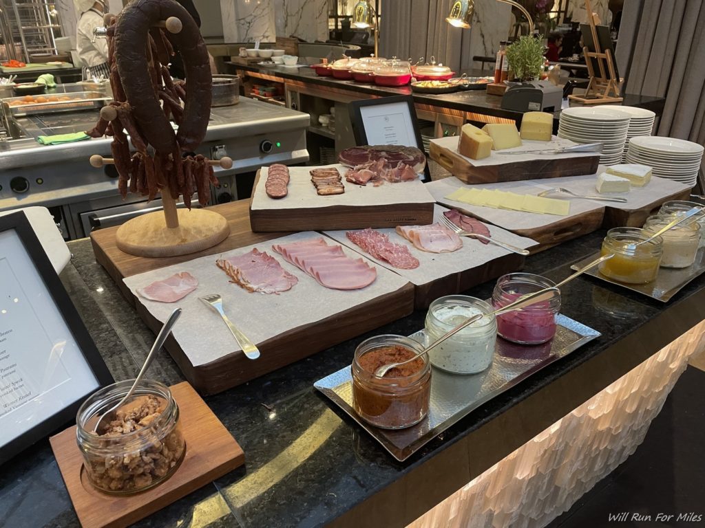 a counter with different types of meats and cheeses
