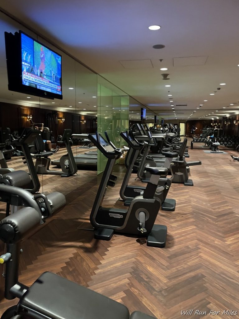 a room with exercise machines and a television